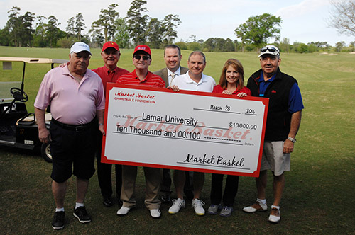 Golf Tournament participants present check